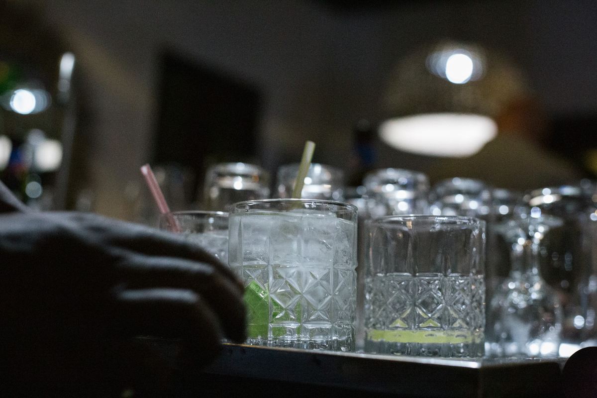 Cocktail glasses with lime lined up on the bar